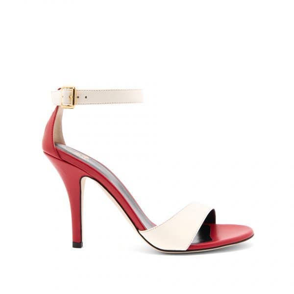 Two-tone high heeled sandal made of red nappa leather, with front band and ankle strap in cream-colored nappa leather, closed with a gold side buckle. 3.9 inches heel