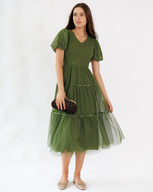 Woman wearing a green dress with a white background
