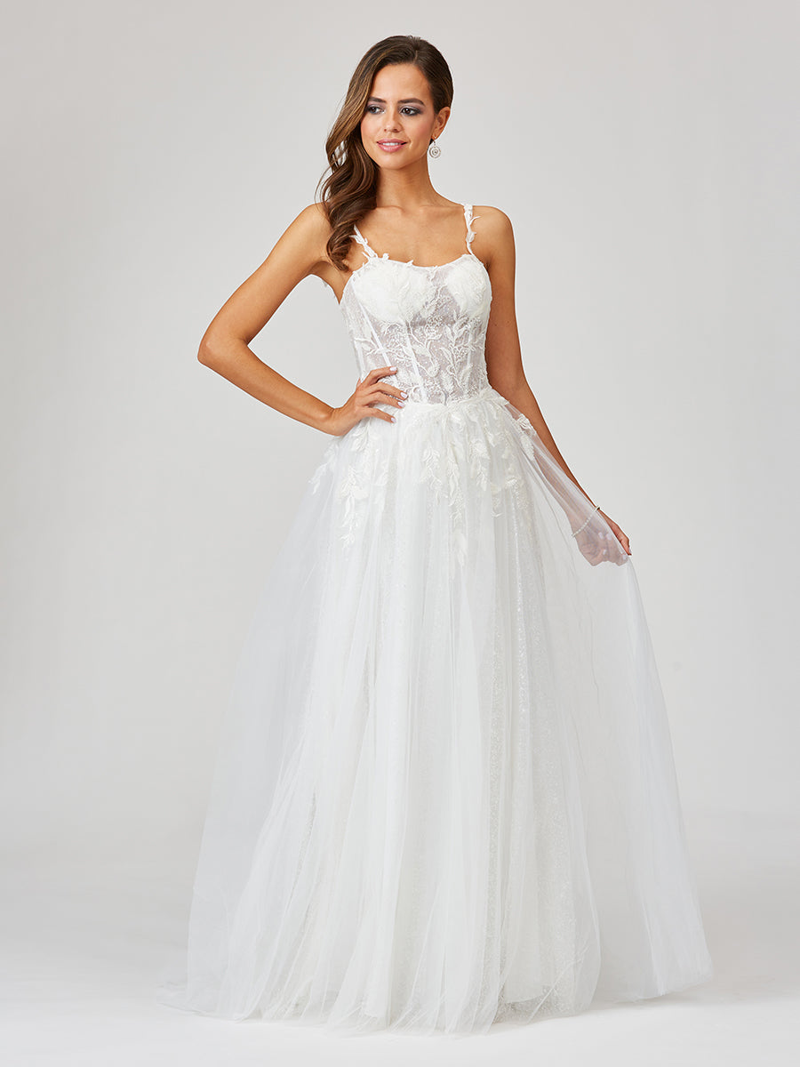 Woman wearing a white wedding dress on a plain background
