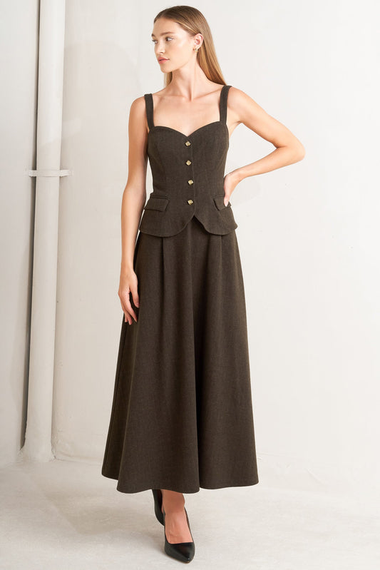 Woman wearing a brown dress with buttons on a white background